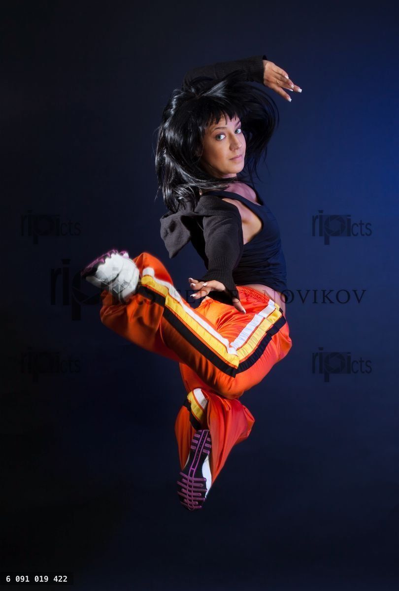 Woman jumping on dark background