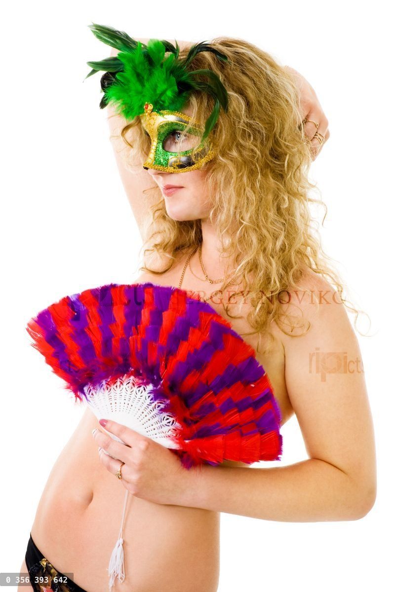 Woman in party mask and fan