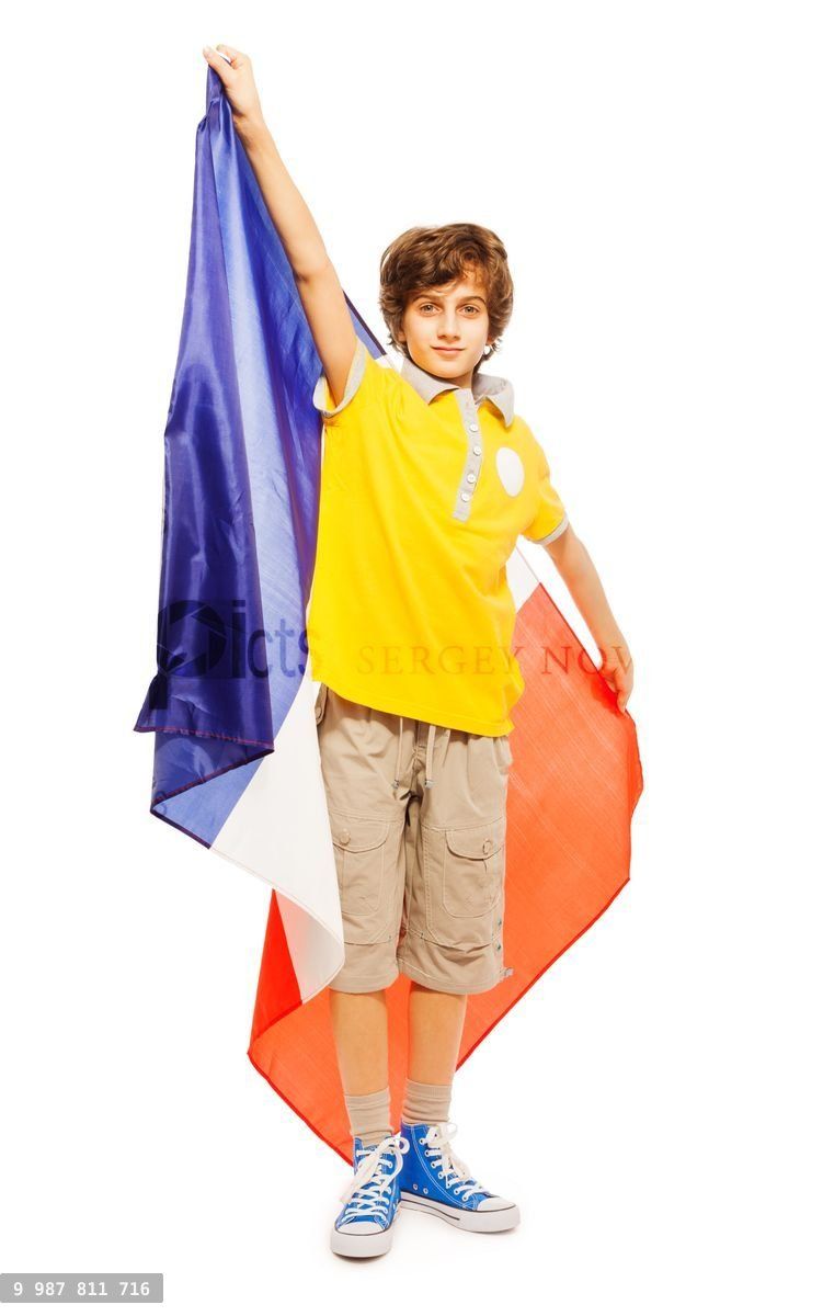 Young boy standing with French flag