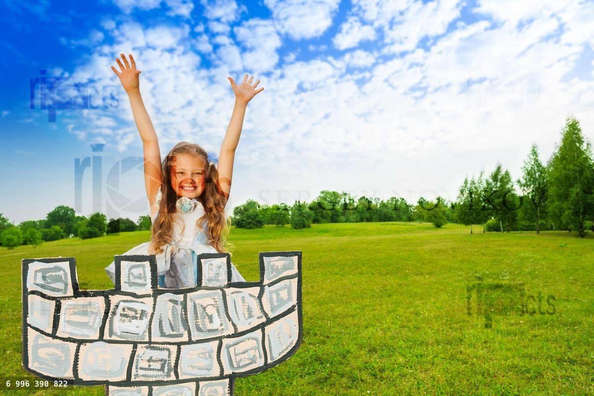 Girl as princess with hands up stands on tower