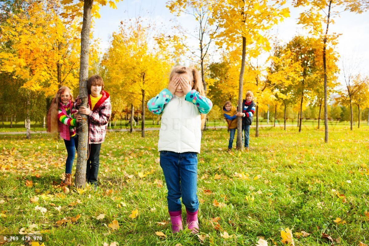 Girl counting, friends hiding