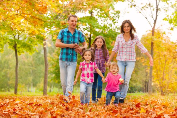 Happy cute family in the autumn October park