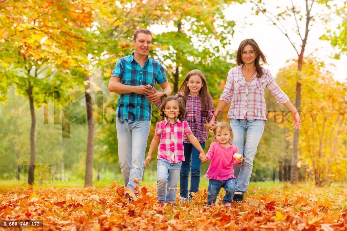 Happy cute family in the autumn October park