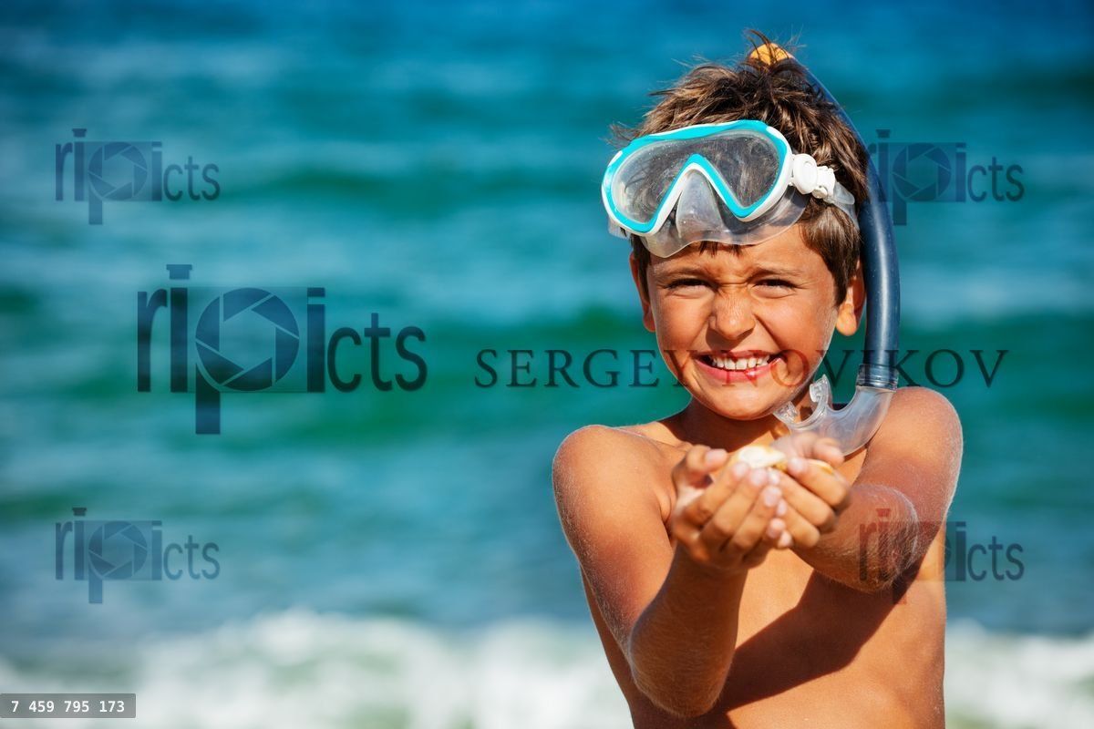 Boy in scuba mask after snorkle show found shells