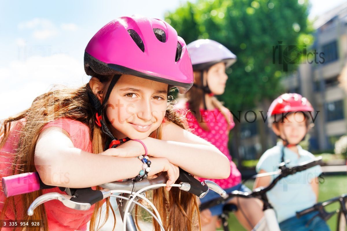 Girl having rest during bicycle ride with friends
