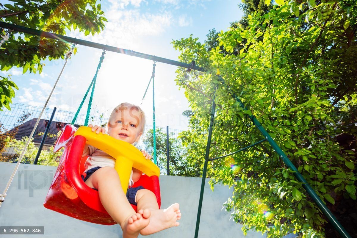 Action photo of toddler swing in the garden
