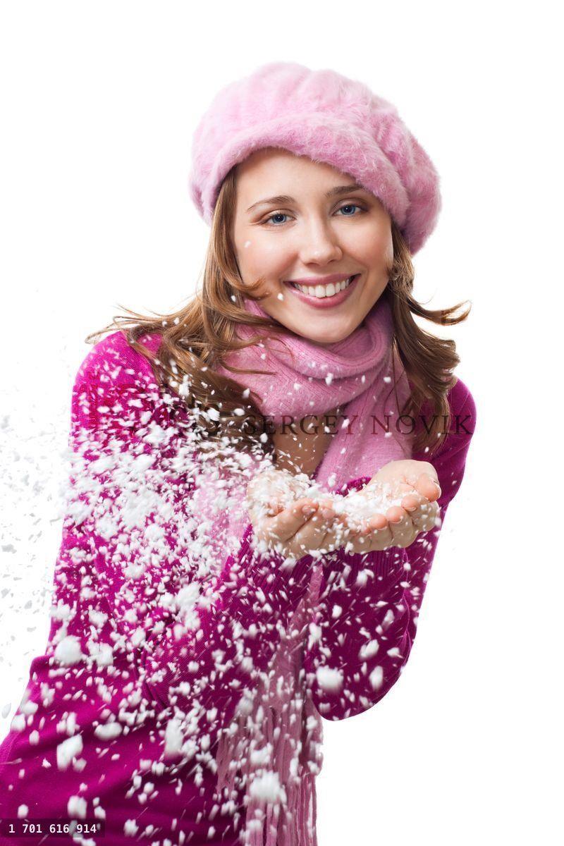 Woman blow snowflakes from hands