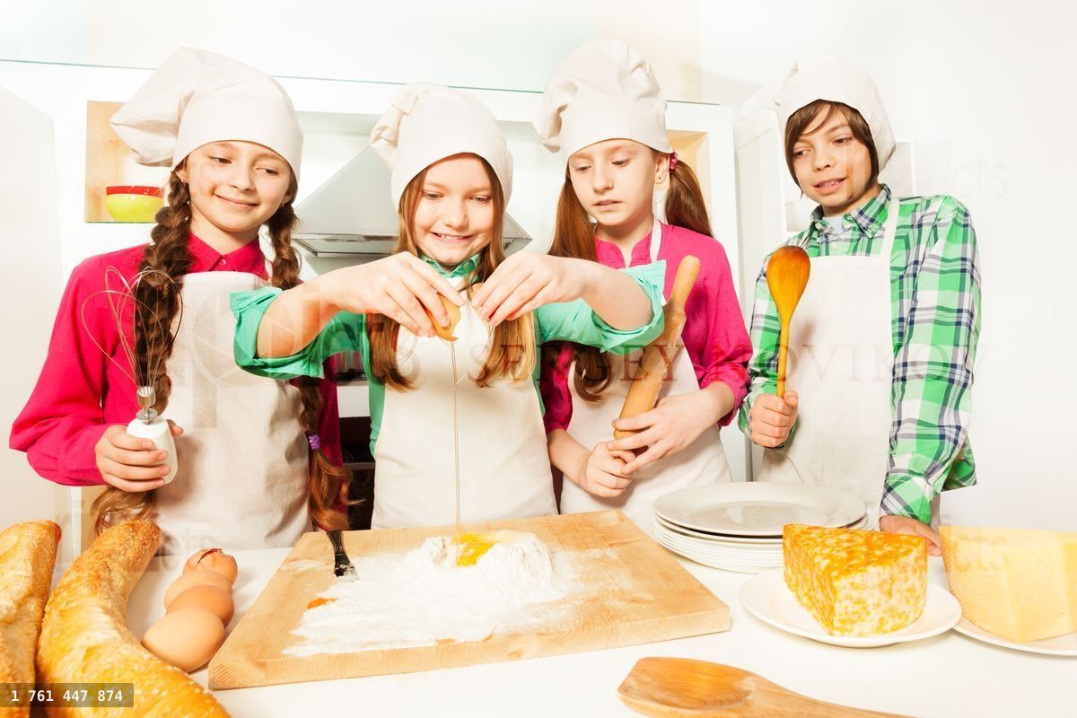 Four young cooks learning to prepare bakery dough