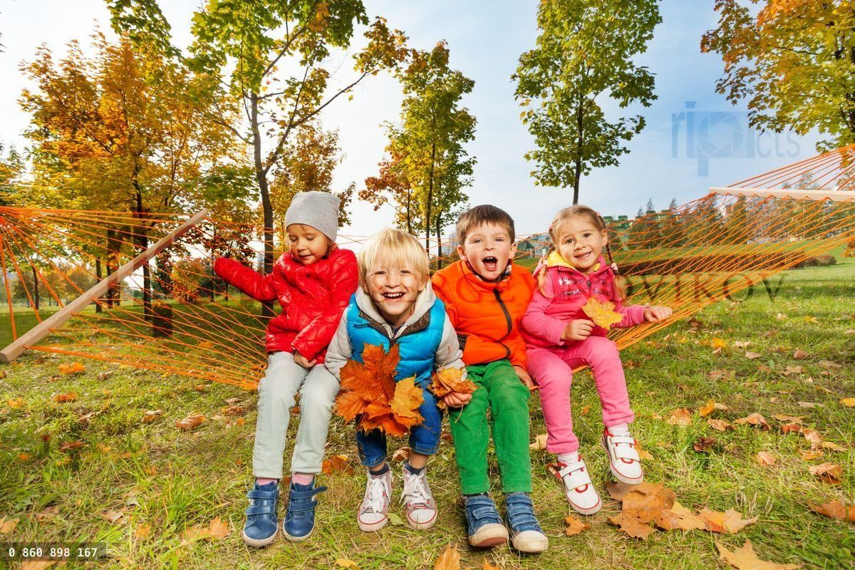 Group of happy kids sit on hammock and enjoy it