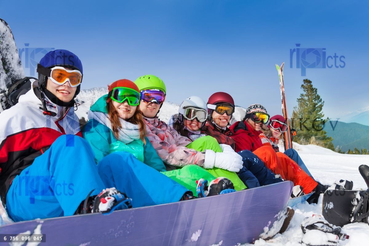Friends with snowboards wearing ski googles