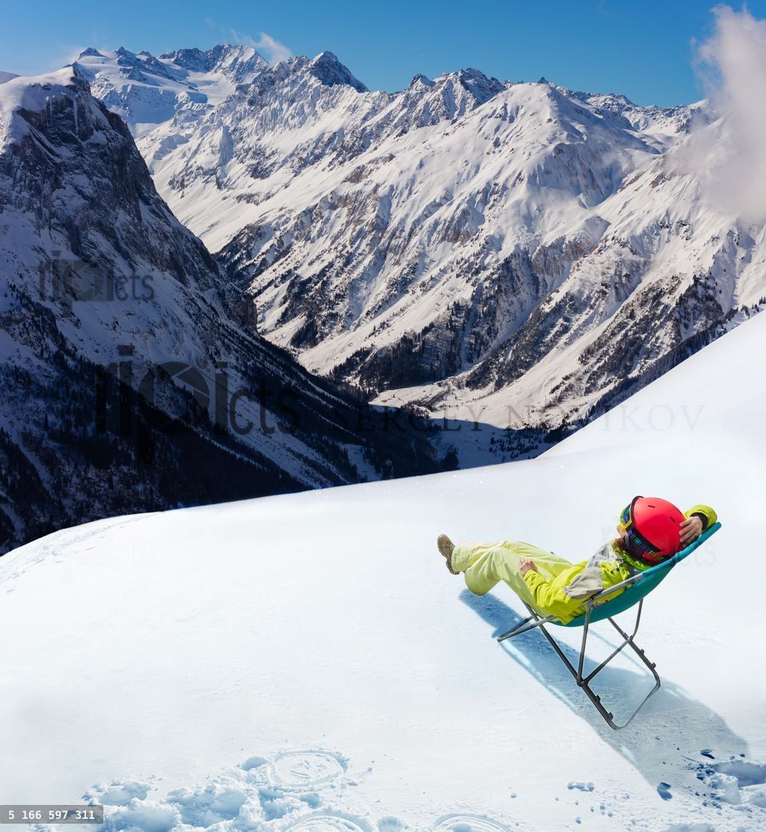 Woman rest in deck chair over mountain peaks view