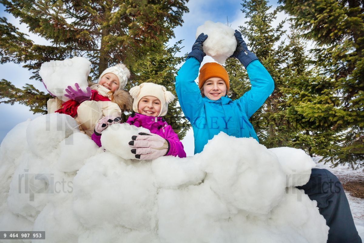 Group of happy children hold snowballs to play