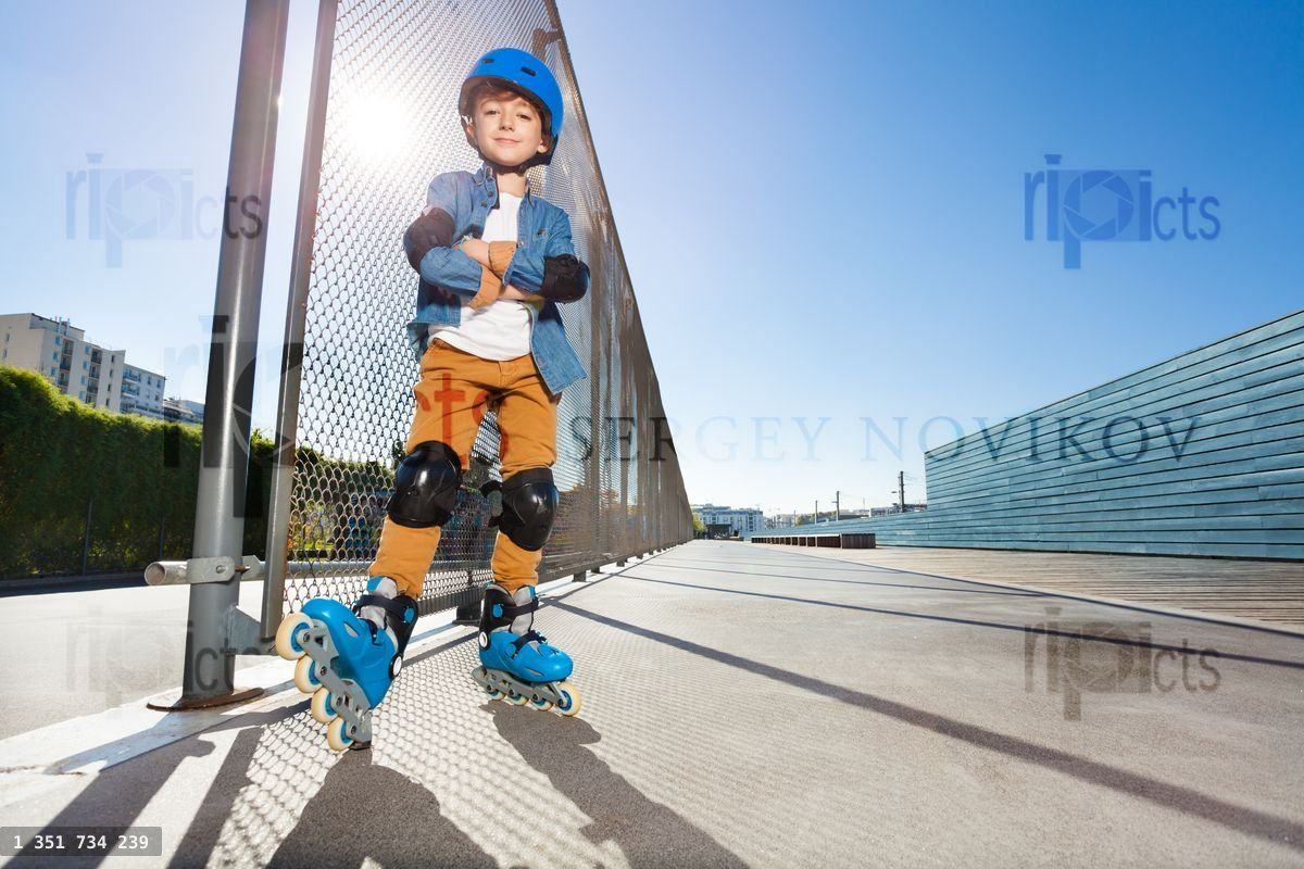 Young inline skater standing at outdoor rollerdrom