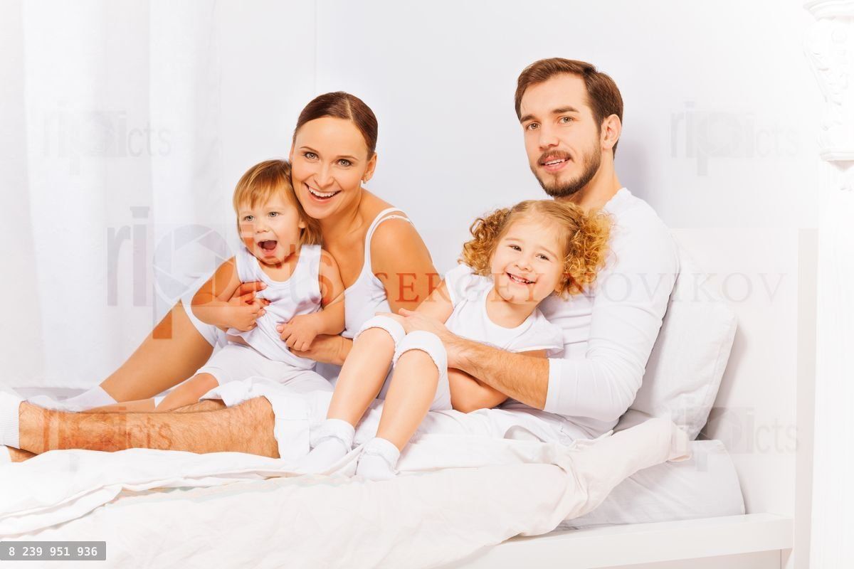 Parents with adorable children in white pajamas
