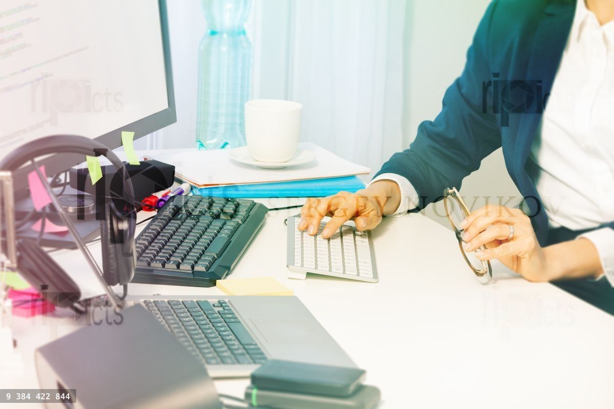 Woman's hands typing on the computer keyboard