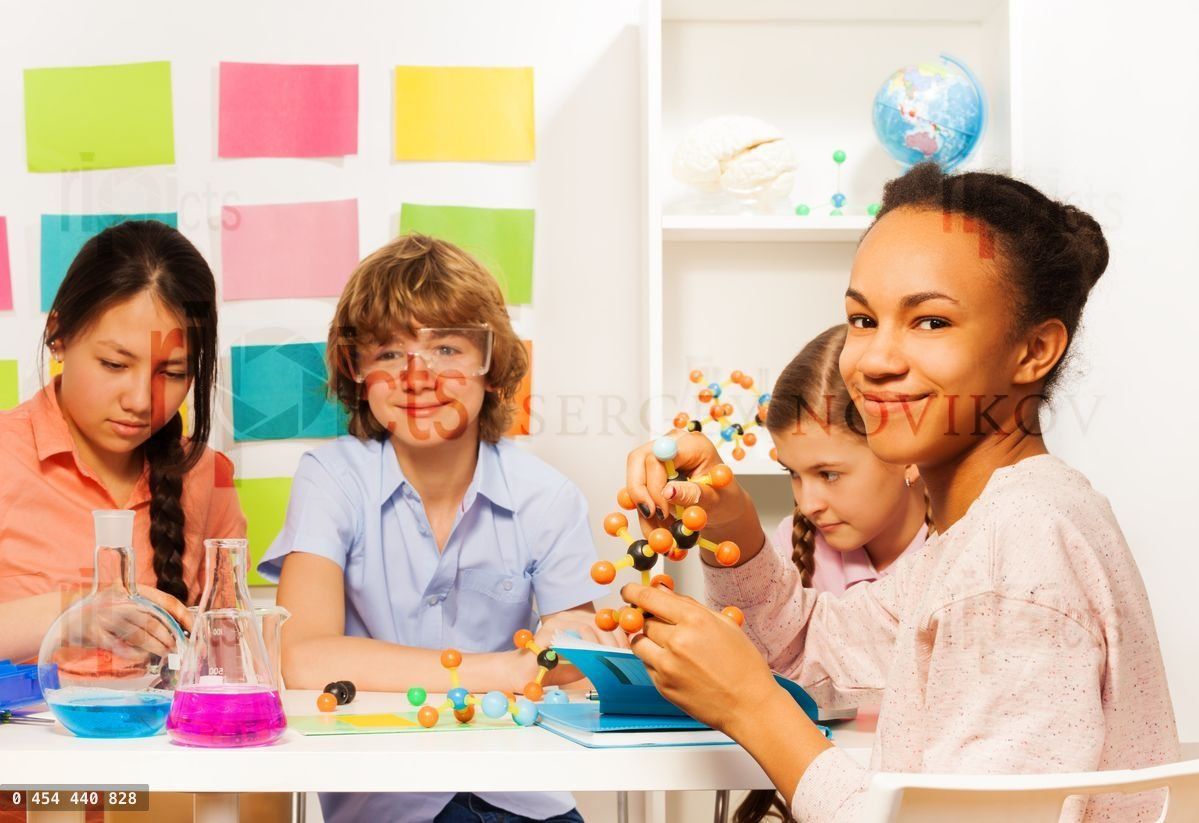 Four multi ethnic students at chemical laboratory