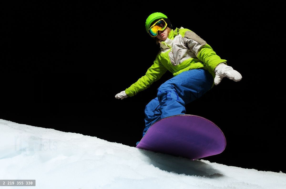 Young woman balancing with hands on snowboard