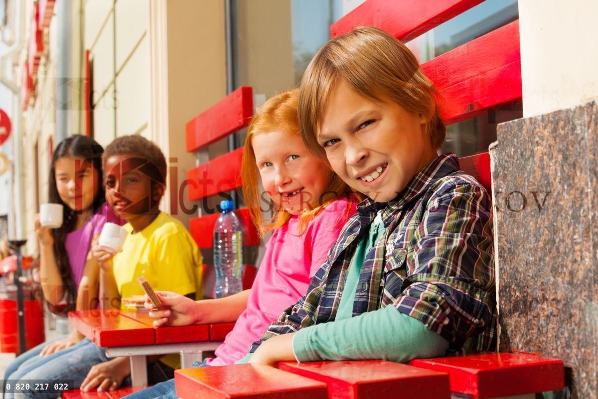 Group of children diversity sit outside in cafe