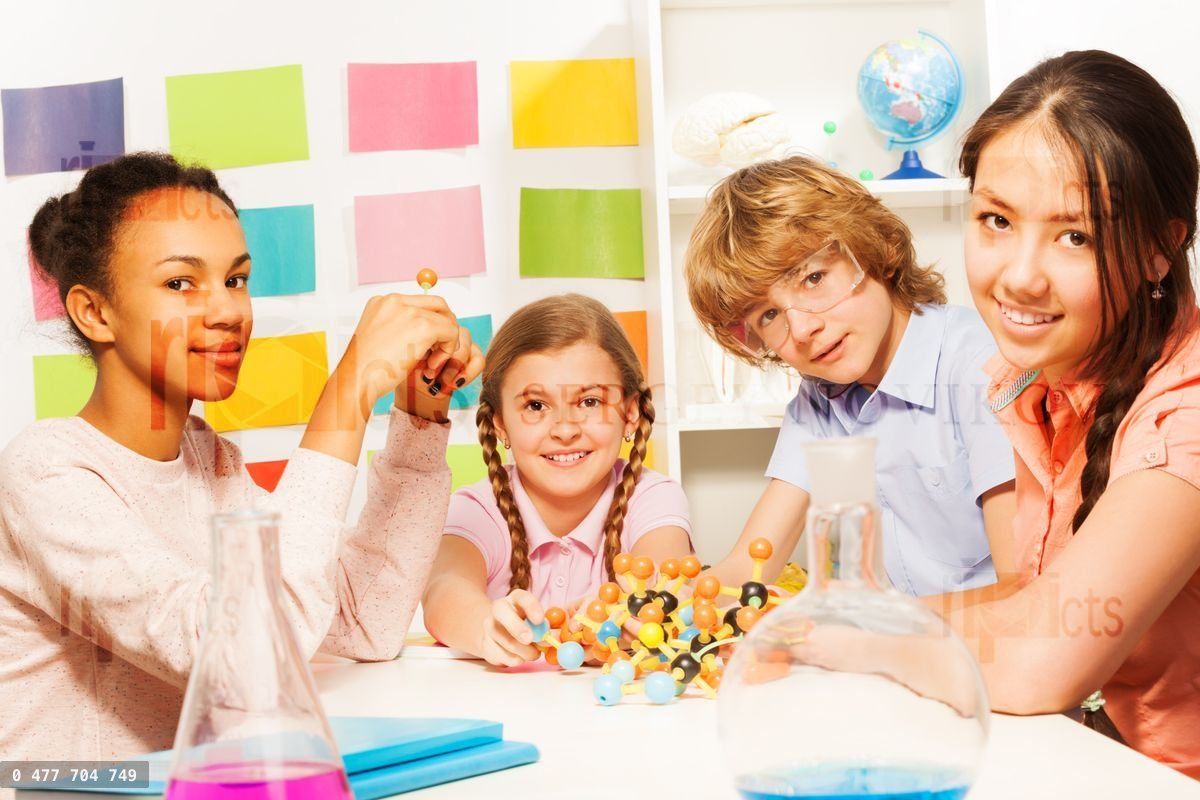 Four young chemists studying molecular structure