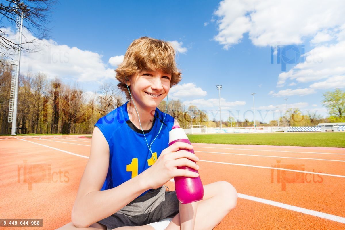 Happy boy having rest after gymnastic activity