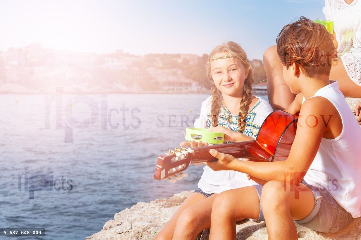 Young band playing music outdoors in summer