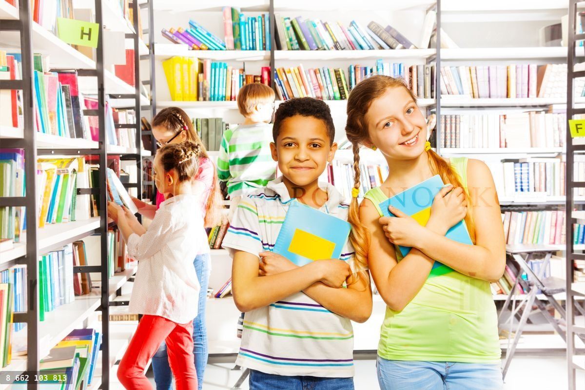 Girl and boy with books together in library