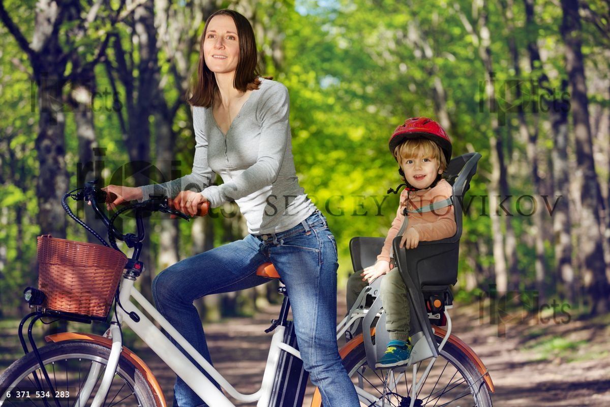 Woman with little blond boy on e bike at backseat