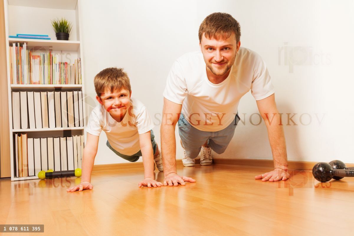 Young father and his son pushing up at the room