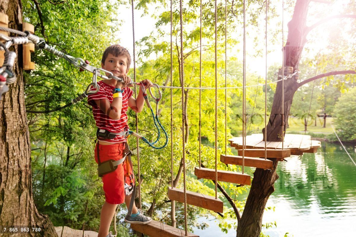 Happy boy pass trial exercise, rope adventure park