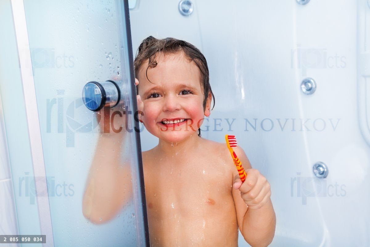 Happy boy with toothbrush showering in the cabin