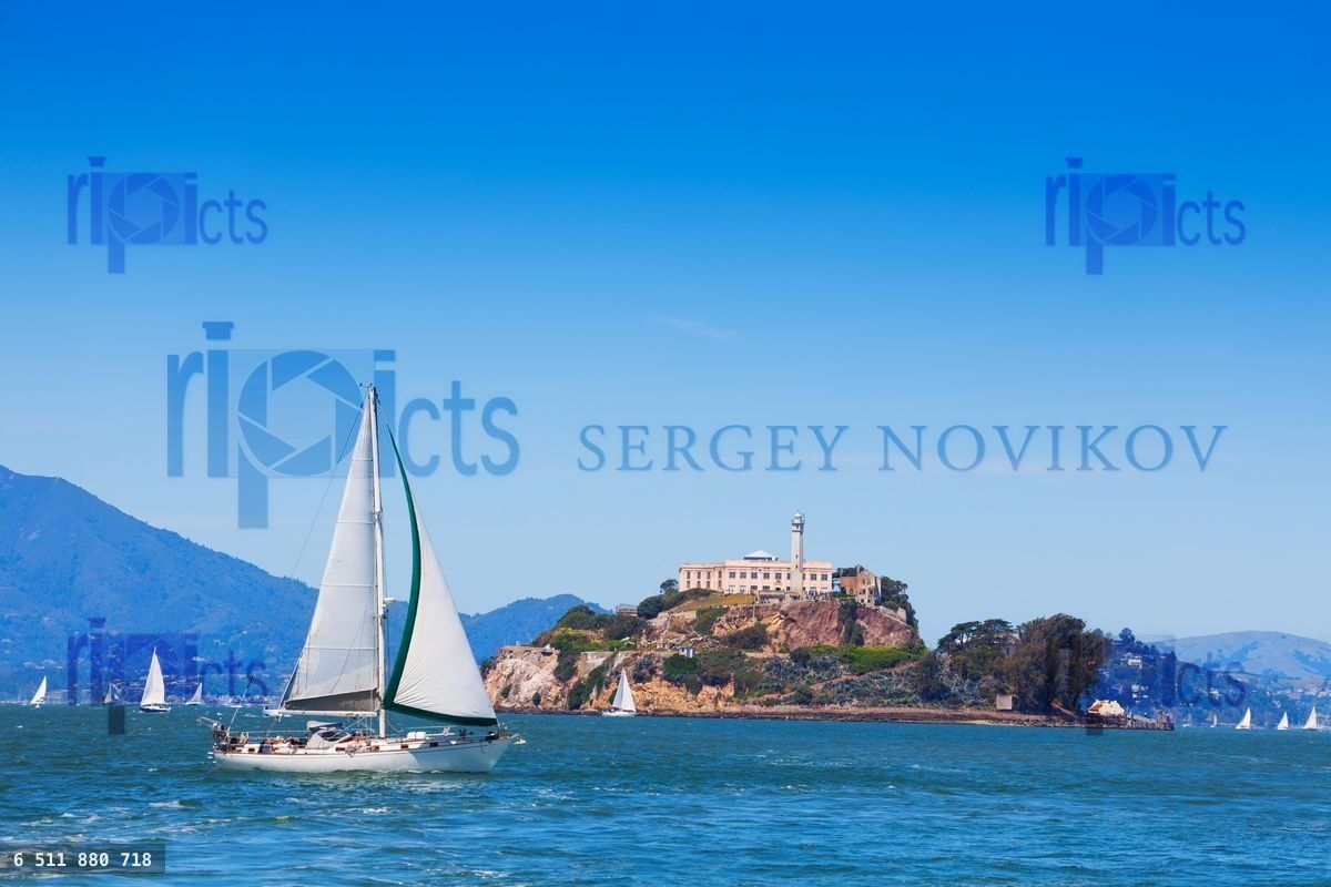 Yacht sail in front of Alcatraz prison island