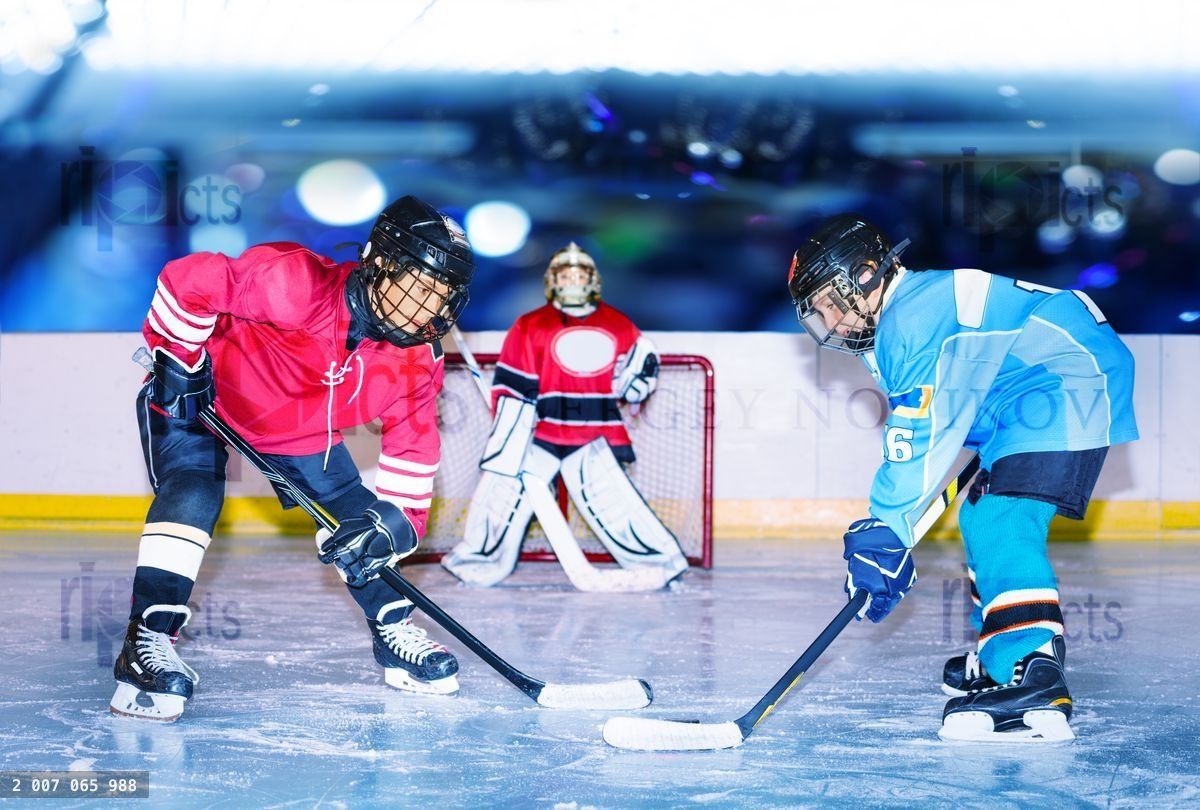 Young hockey defenseman in action on ice rink