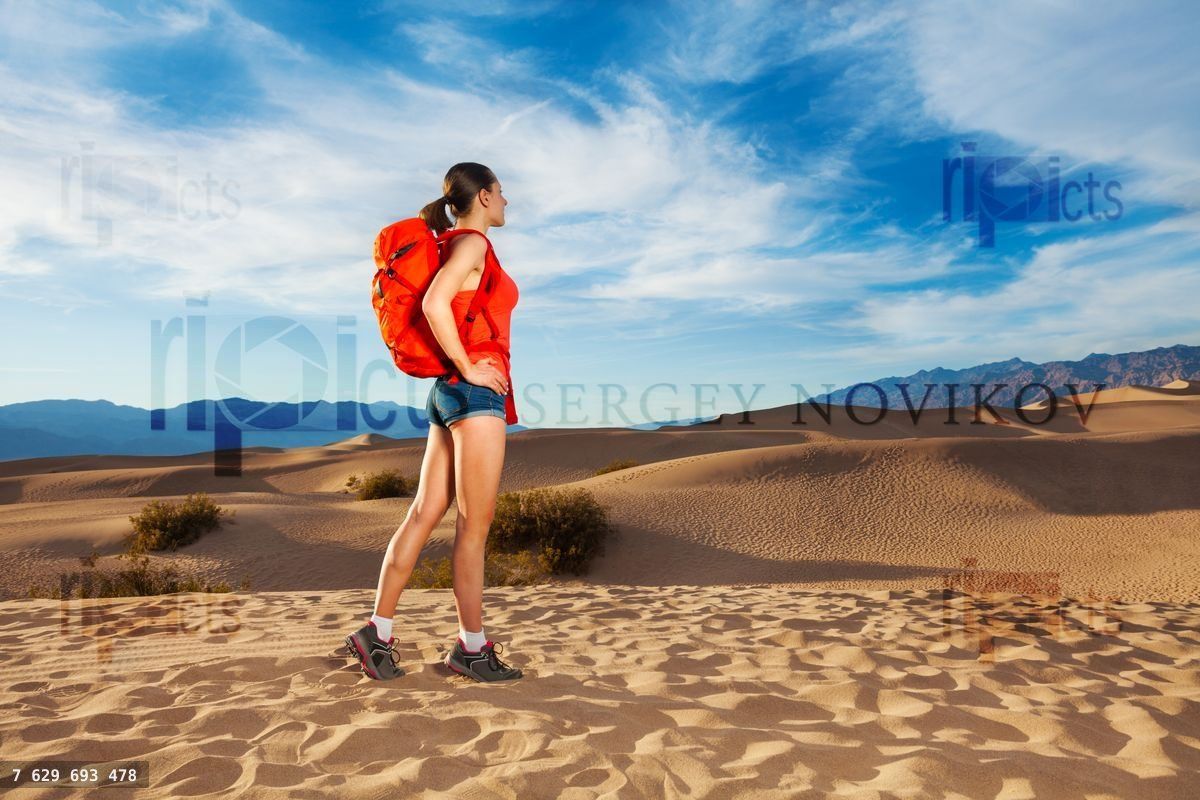 Woman with rucksack standing in Death valley