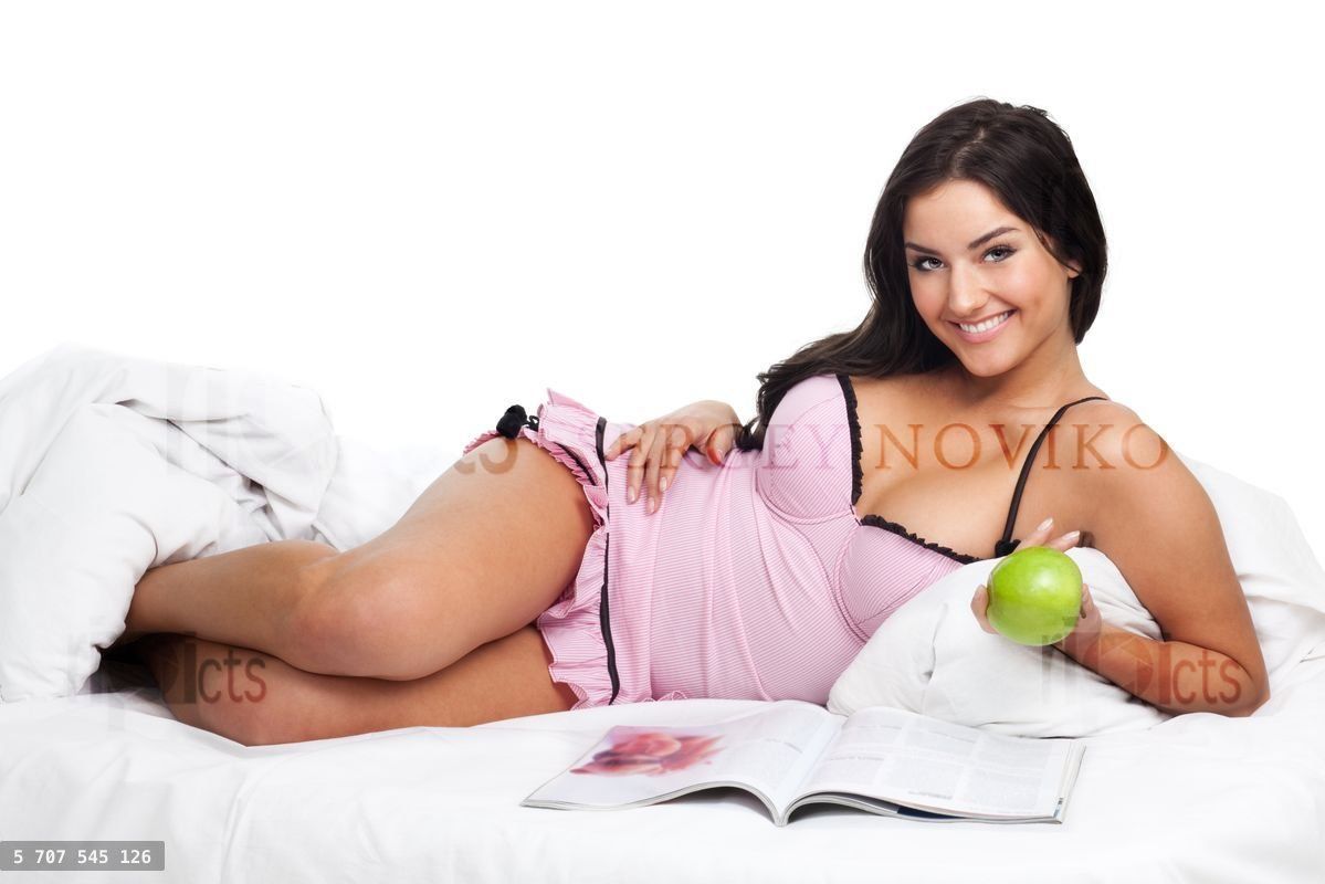 Young woman with smile lay in bed and smile