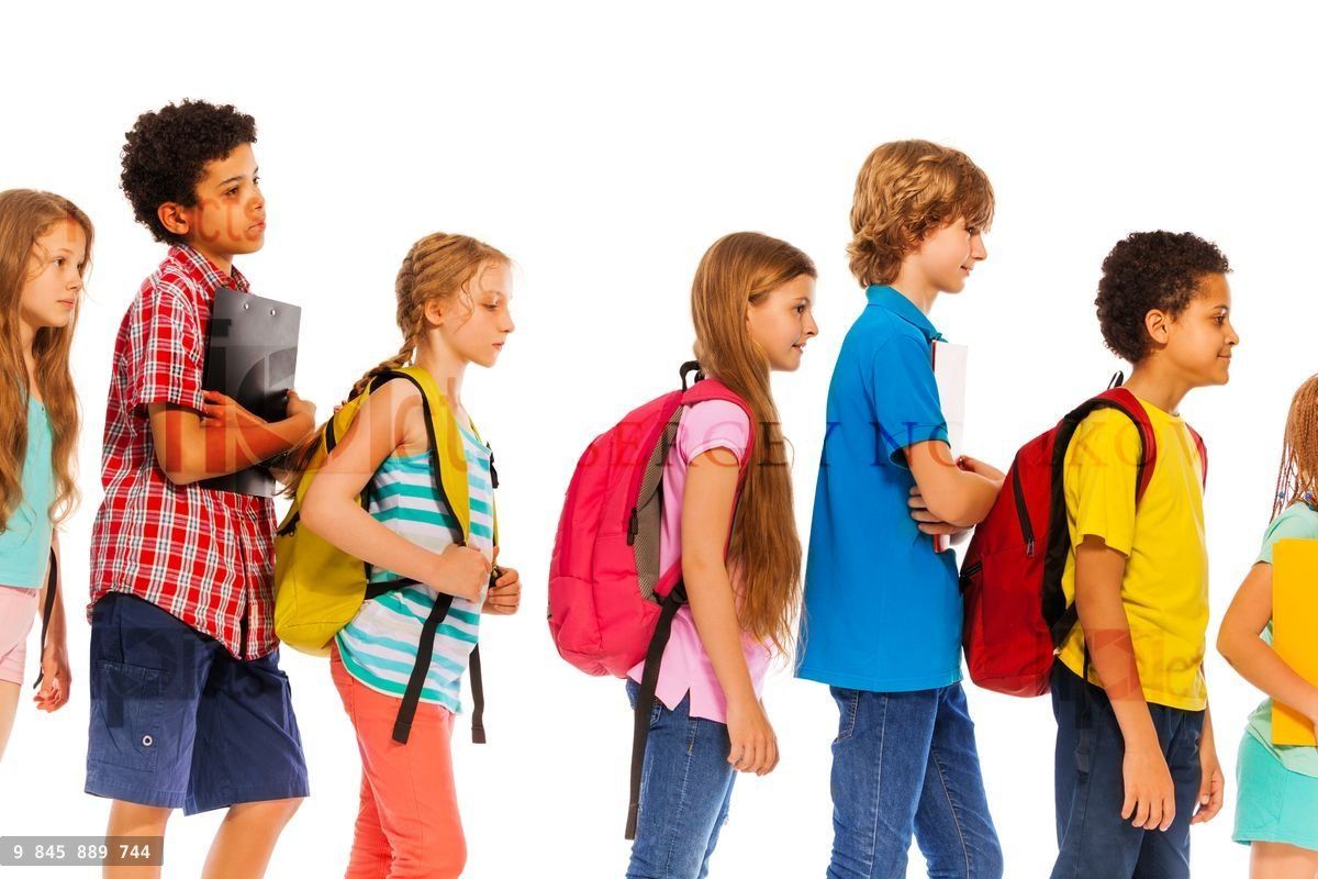 School kids go in line with backpacks profile view