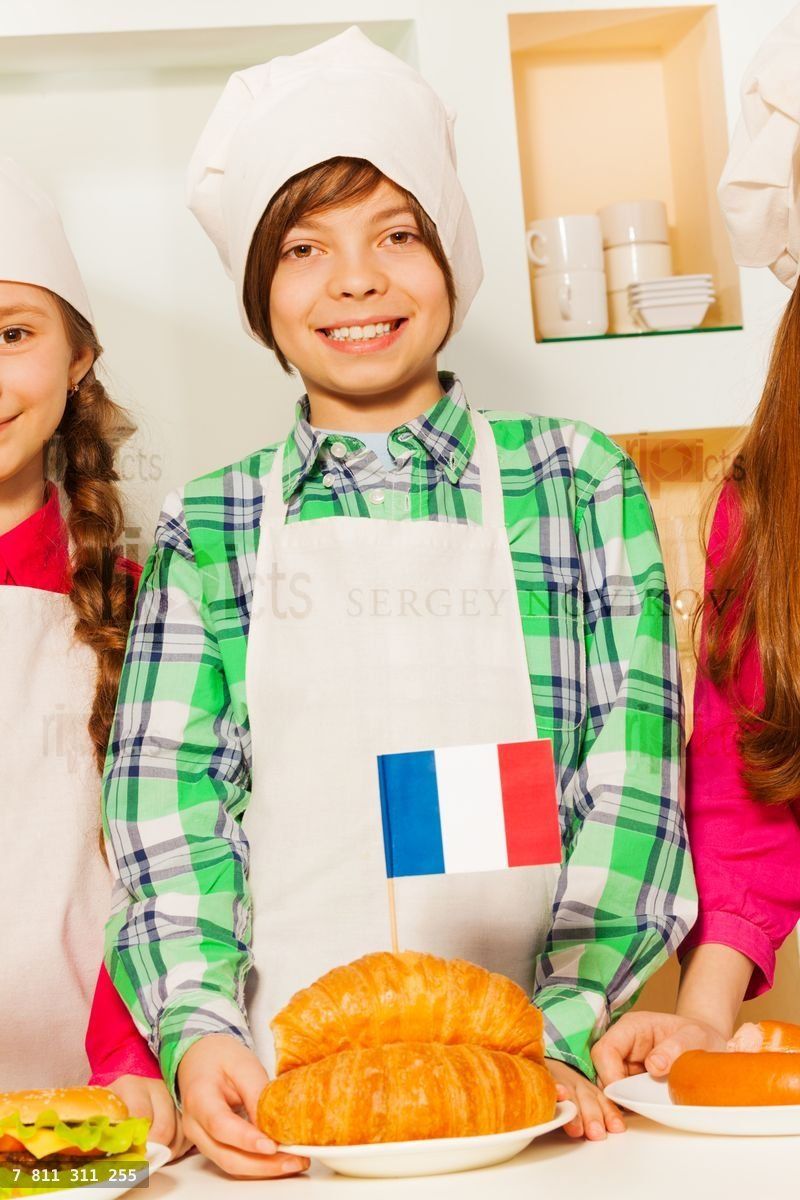 Young cook with fresh tasty French croissants