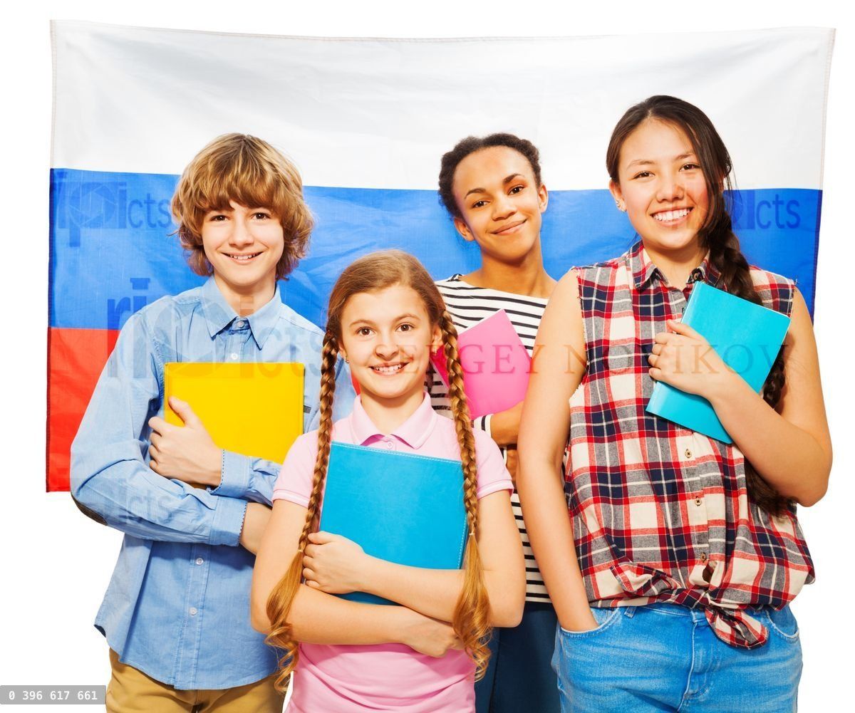Four happy students standing against Russian flag