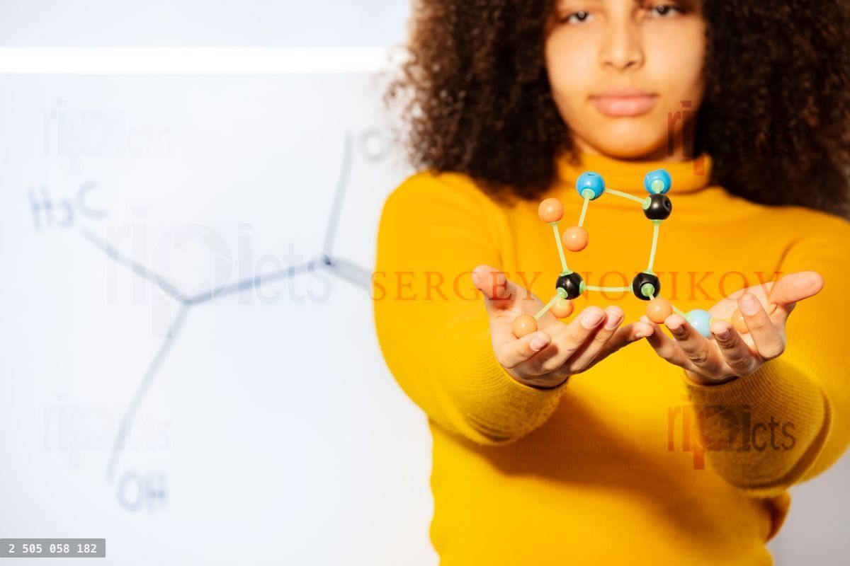 Closeup of acid molecule in student girls hands