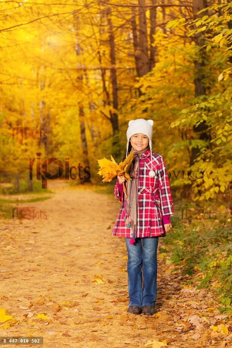 Cute Asian girl with bunch of yellow leaves alone