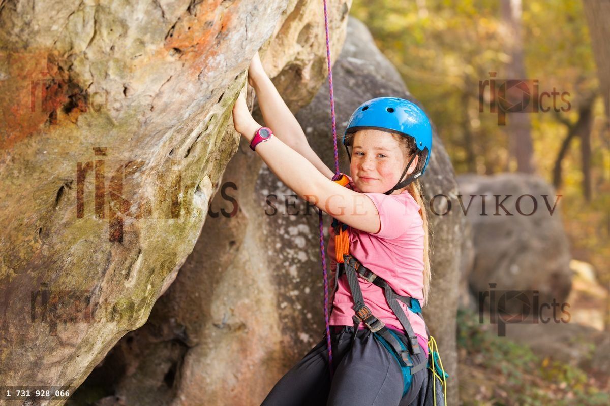 Young mountaineer training rock climbing outdoors