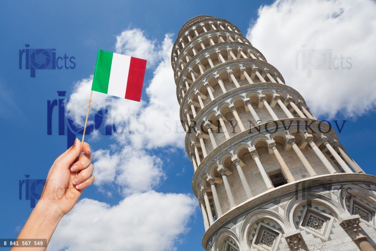 Hand with Italian flag against the Tower of Pisa