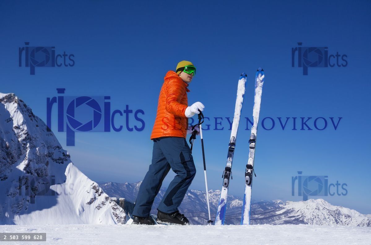 Young man standing alone with ski in snow