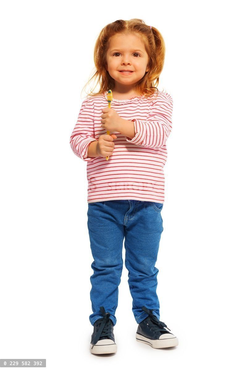 Funny little girl holding yellow toothbrush