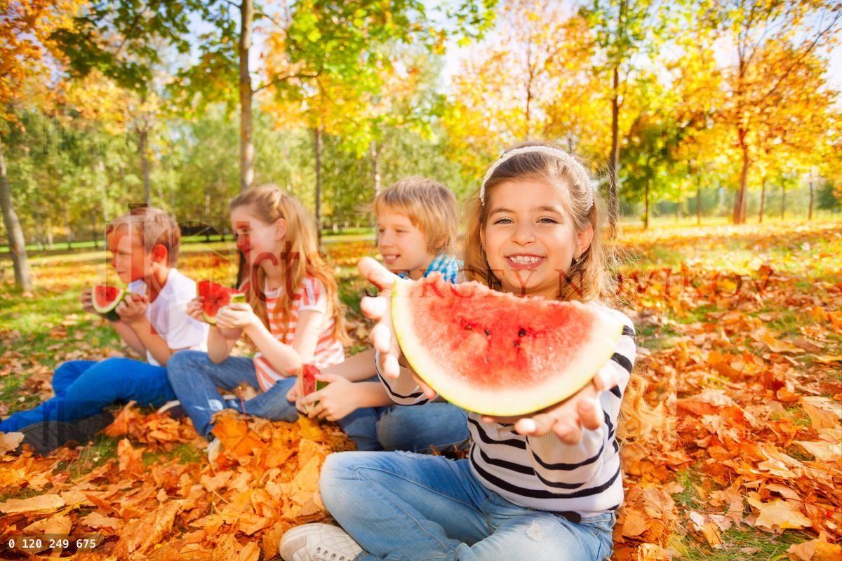 Happy kids holding watermelon and eating
