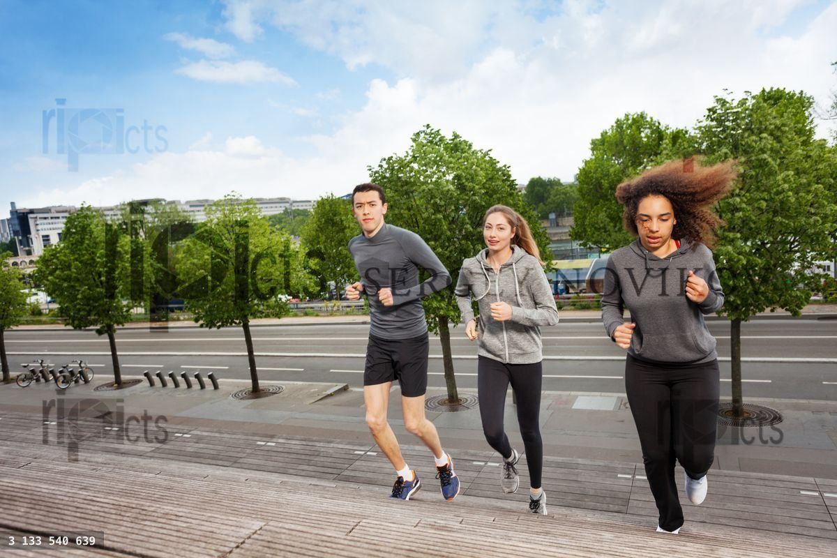 Young people running upstairs on city stairs