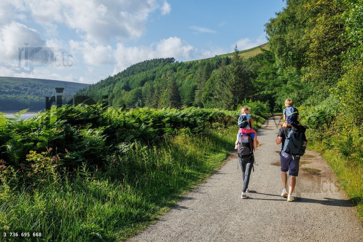 Family walk, children ride on shoulders along Howden reservoir