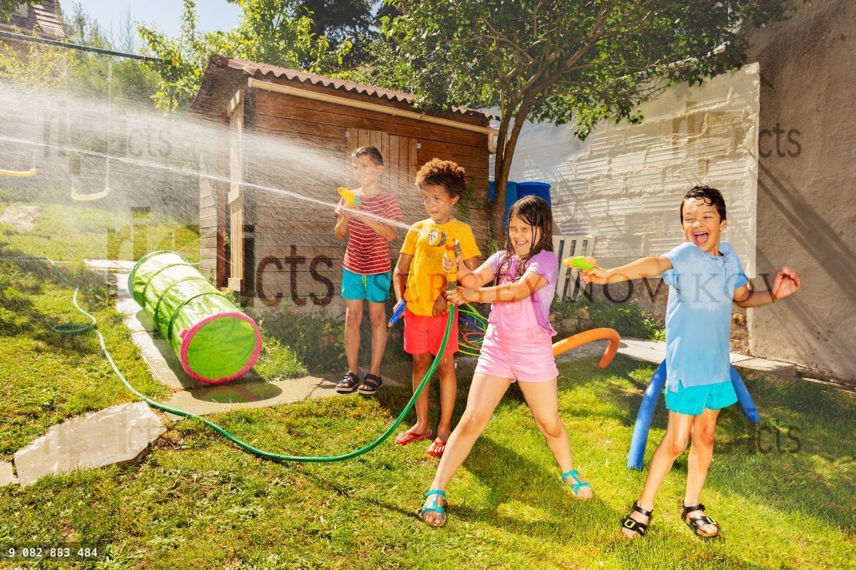 Friends play water gun fight in the garden