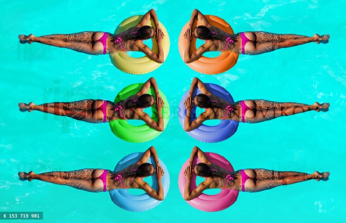 Women on inflatable different color buoys in water