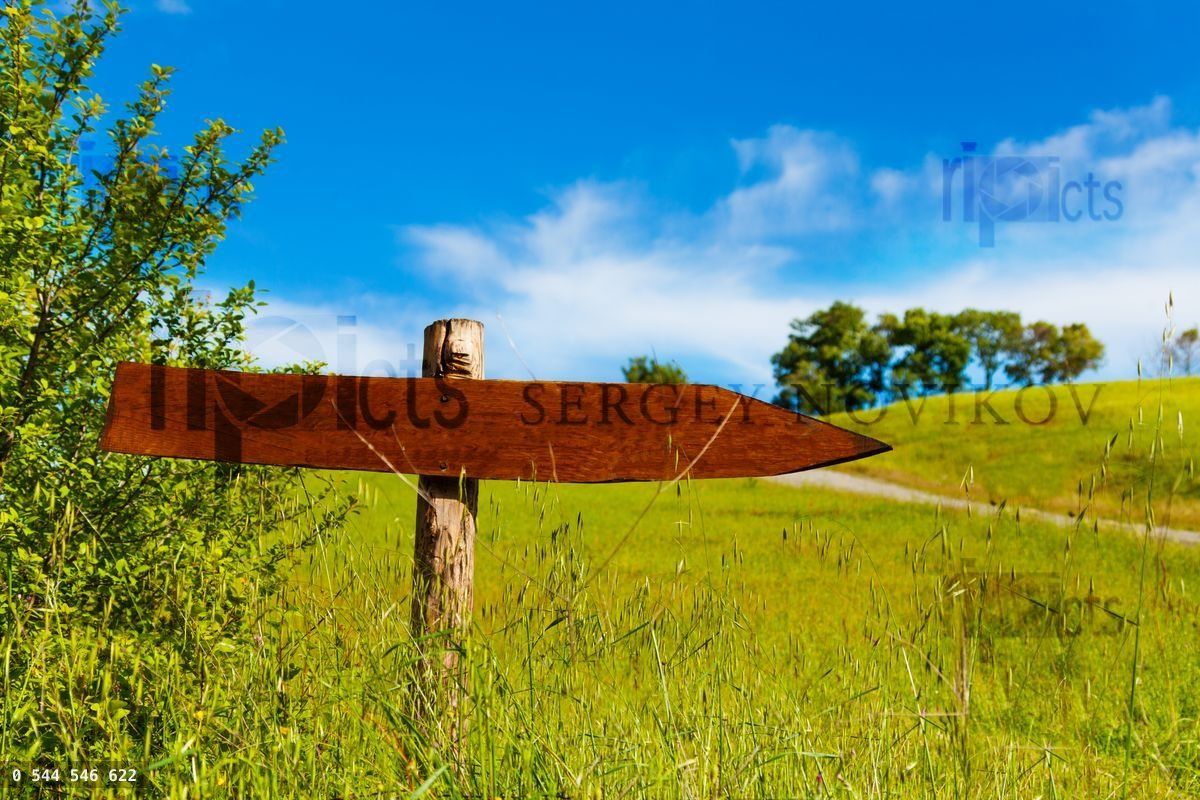 Wooden arrow sign in the valley