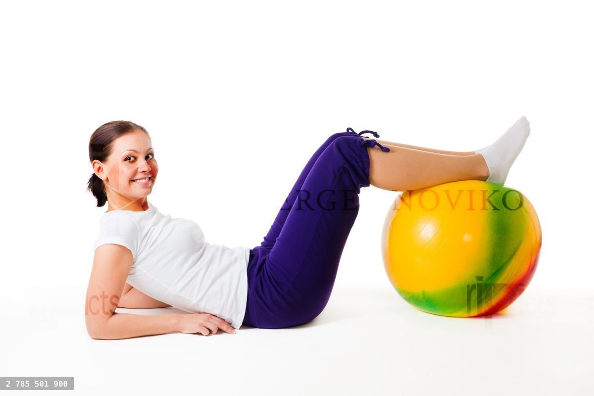 Woman doing fitness exercises with ball